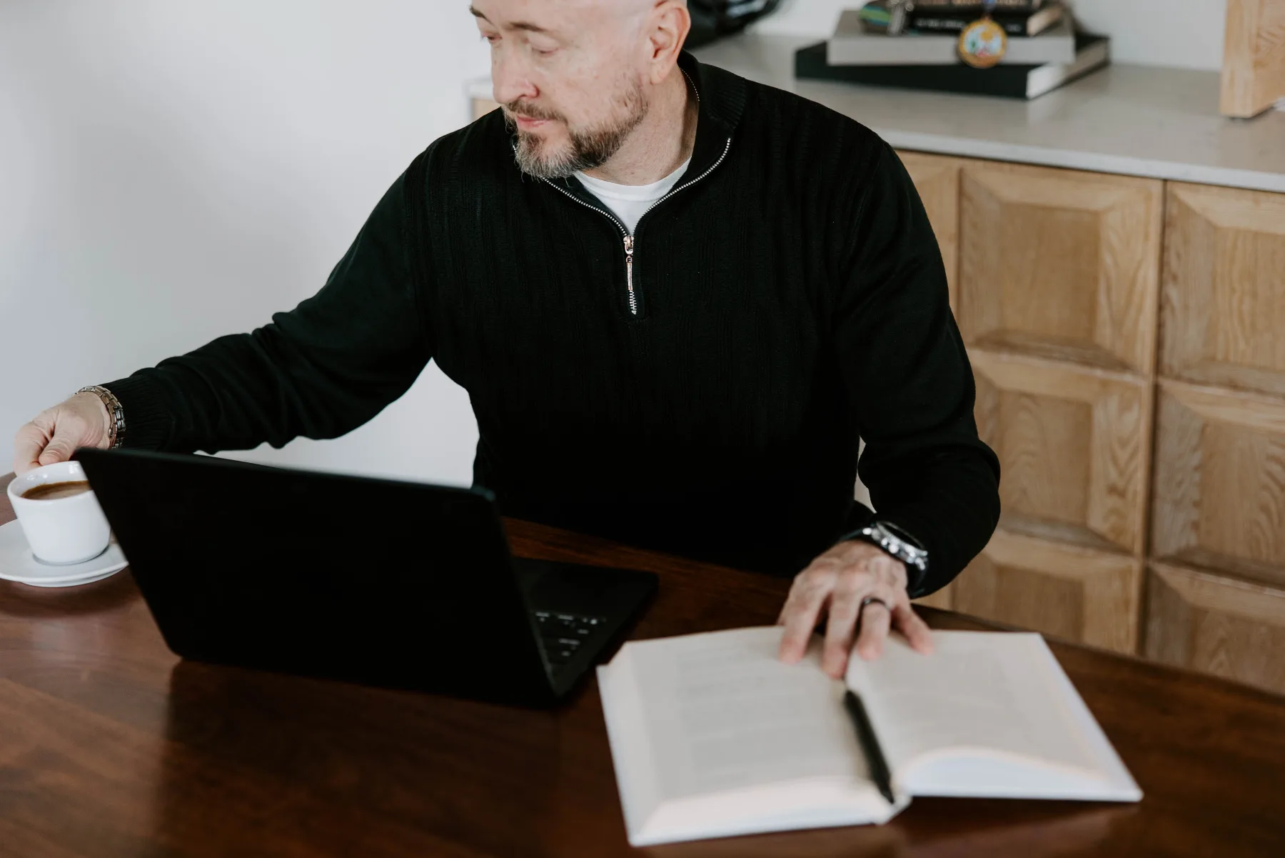 Darrell Adolph reviewing notes beside his laptop